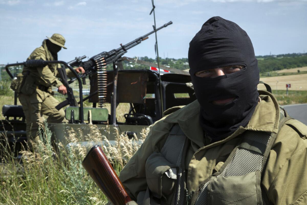 Pro-Russia fighters guard an antiaircraft position near Luhansk in eastern Ukraine on Wednesday as government troops waged a broad offensive against the separatists.