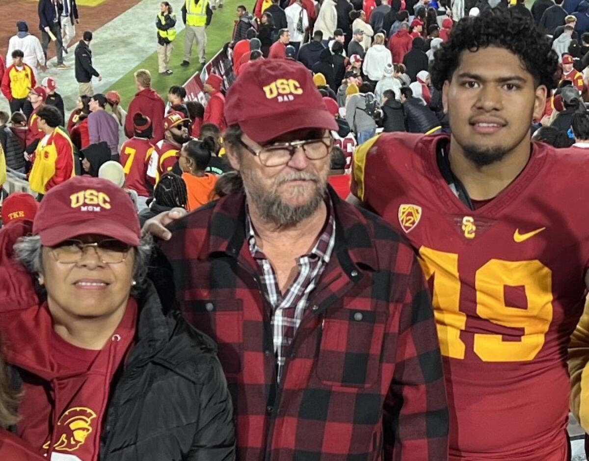 Tuli Tuipulotu with his aunt and uncle, Lupe and Ken Fosnight, after a USC football game. 