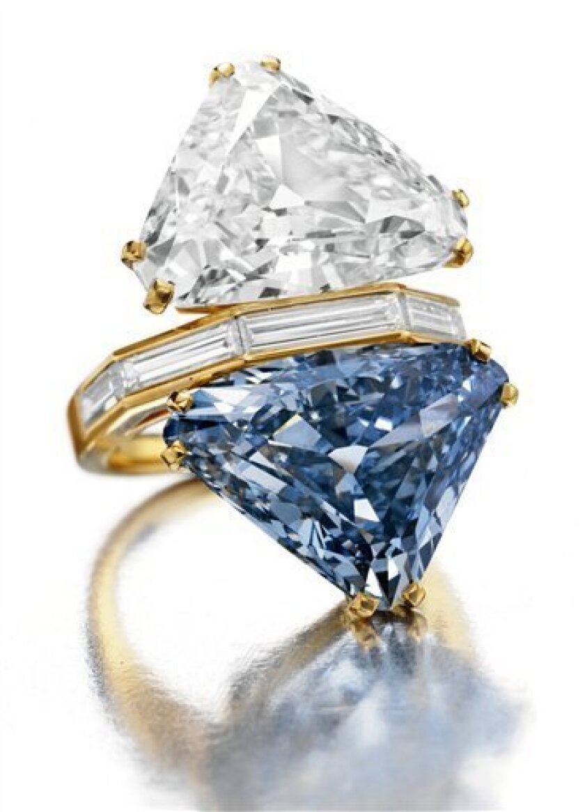 This undated photo provided in New York by Christie's Images LTD.2010, shows a two-stone ring with a 10.95-carat triangular-shaped blue diamond. The ring, designed by the Italian luxury jeweler Bulgari, is expected to bring in excess of $15 million when it's offered for sale Oct. 20, 2010, in New York. The ring is paired with a 9.87-carat white diamond. (AP Photo/Christie's Images LTD.2010) NO SALES