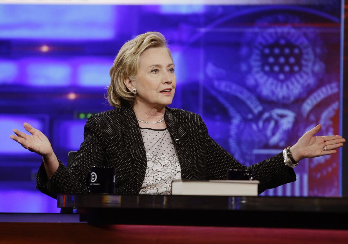 Former Secretary of State Hillary Rodham Clinton gestures while speaking to host Jon Stewart during a taping of "The Daily Show with Jon Stewart" on Tuesday.