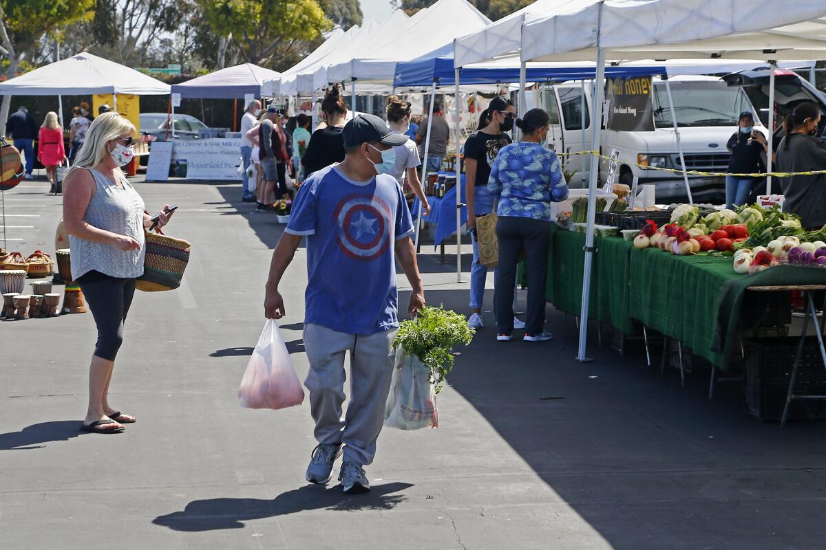 Shoppers explore the various vendors during the Farmers Market in April at the O.C. fairgrounds.