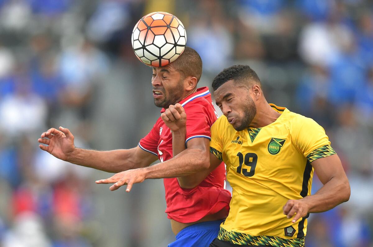 Costa Rica's Alvaro Saborio, left, and Jamaica's Adrian Mariappa try to head the ball during the second half of a CONCACAF Gold Cup soccer match at the StubHub Center.