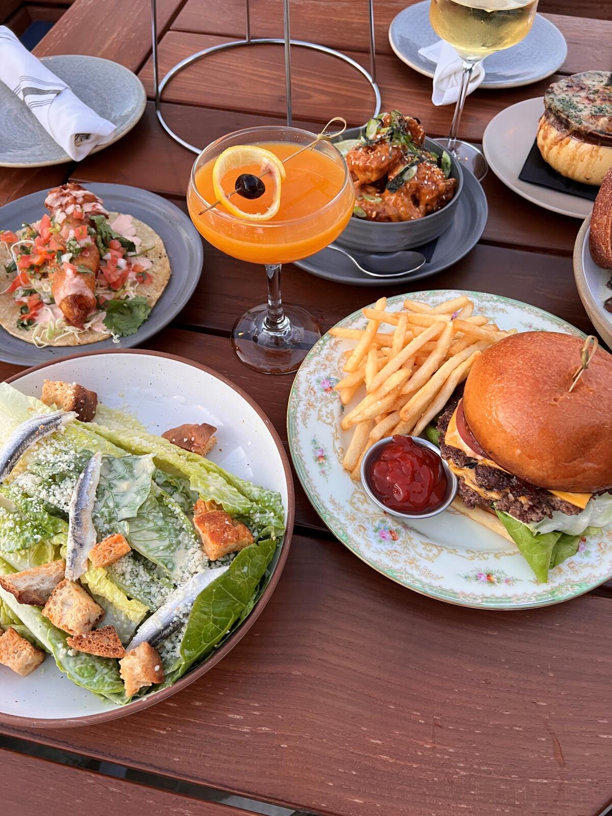 A burger, tacos,salad, soup and other items at Sandpiper Wood Fired Grill & Oysters in La Jolla Shores.