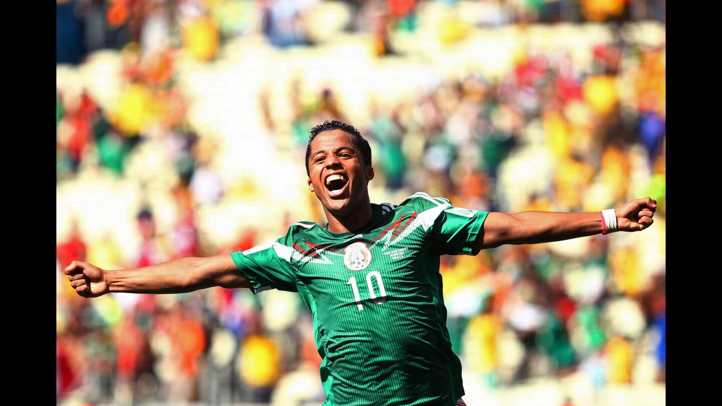 Giovani dos Santos of Mexico celebrates scoring his team's first goal during the 2014 FIFA World Cup Brazil Round of 16 match between Netherlands and Mexico at Castelao on June 29, 2014, in Fortaleza, Brazil.