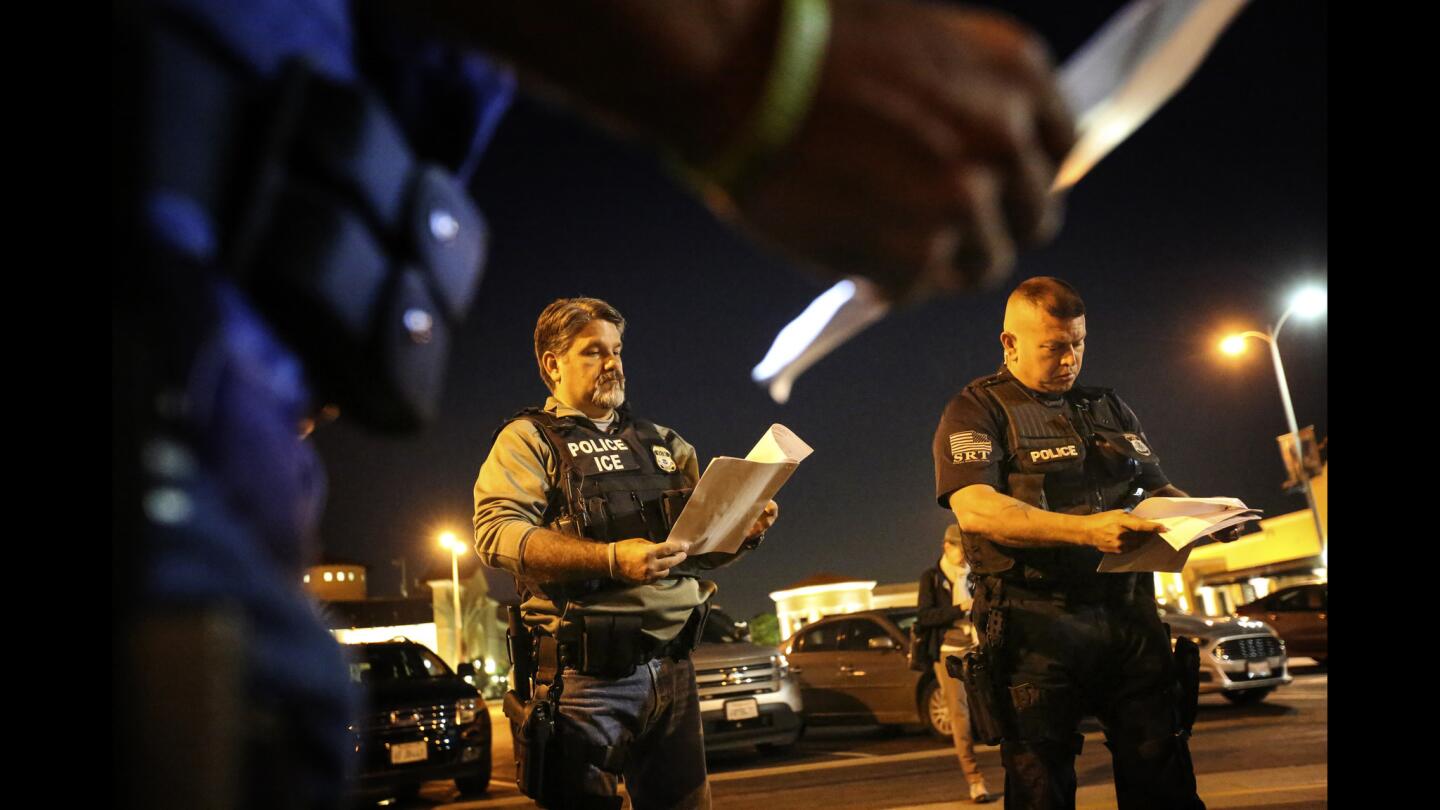 Federal agents are briefed before going out into the Riverside community to apprehend immigrants who may be deportable. In the past, the agency would simply contact local jails where such immigrants were being detained and ask jail officials to hold them until an ICE van could pick them up, but hundreds of counties across the country stopped honoring such requests after a federal judge last year found that practice unconstitutional.