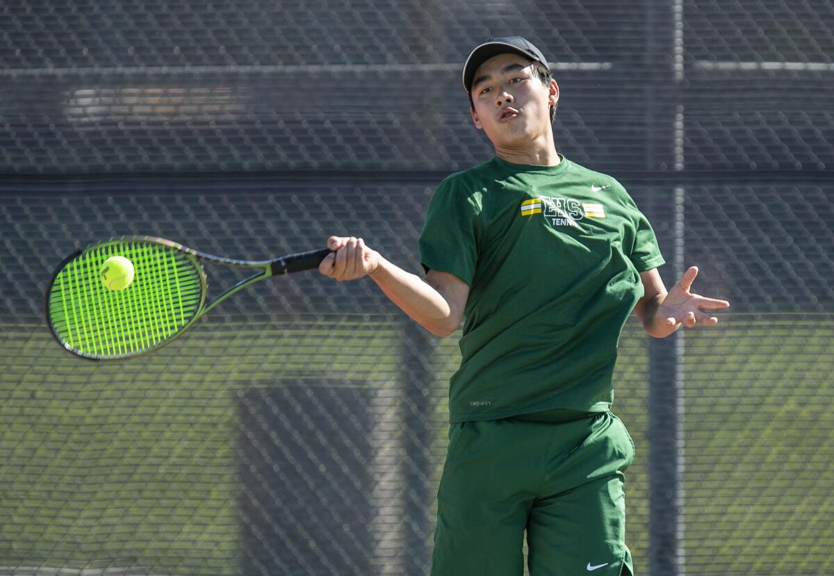 Edison's Dylan Trinh hits a forehand in Thursday's Wave League match against Huntington Beach at Huntington Beach High.