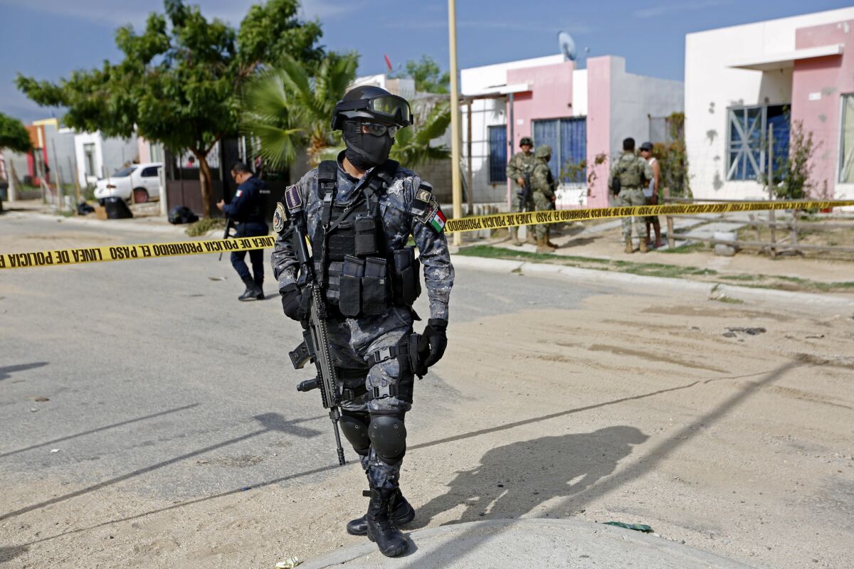 A Mexican federal police officer at the scene of a homicide in Los Cabos, Mexico, in 2017.