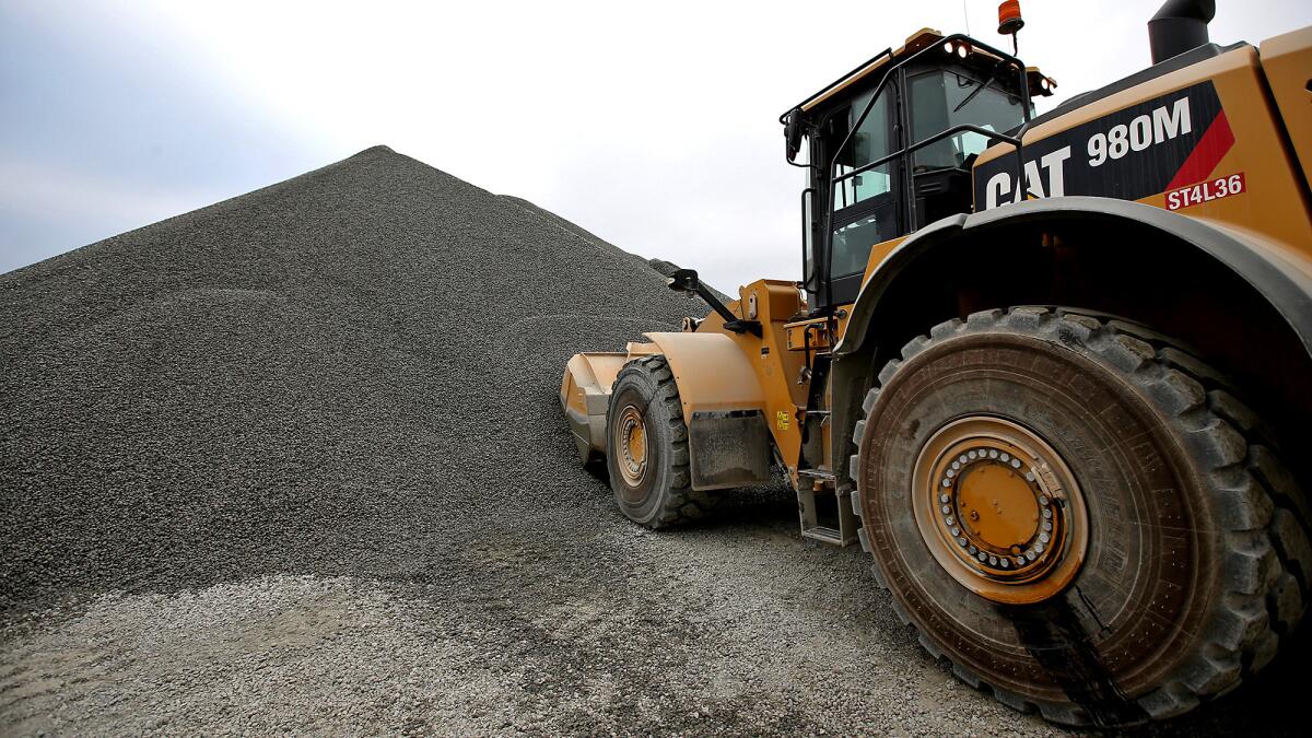 Gravel from Polaris' Orca quarry is piled up and stored at the Port of Long Beach (Luis Sinco / Los Angeles Times).