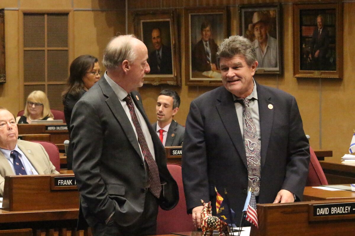 FILE - Senate Majority Leader Rick Gray, left, a Republican, talks to Senate Democratic Leader David Bradley during a break in budget votes at the Arizona state Capitol in Phoenix, on Monday, May 27, 2019. Bradley, a Tucson Democrat who served 16 years in the Arizona Legislature with stints in both chambers and who was praised by former colleagues as a compassionate advocate and thoughtful public servant, died Saturday., Feb. 19, 2022 He was 69. (AP Photo/Jonathan J. Cooper, File)