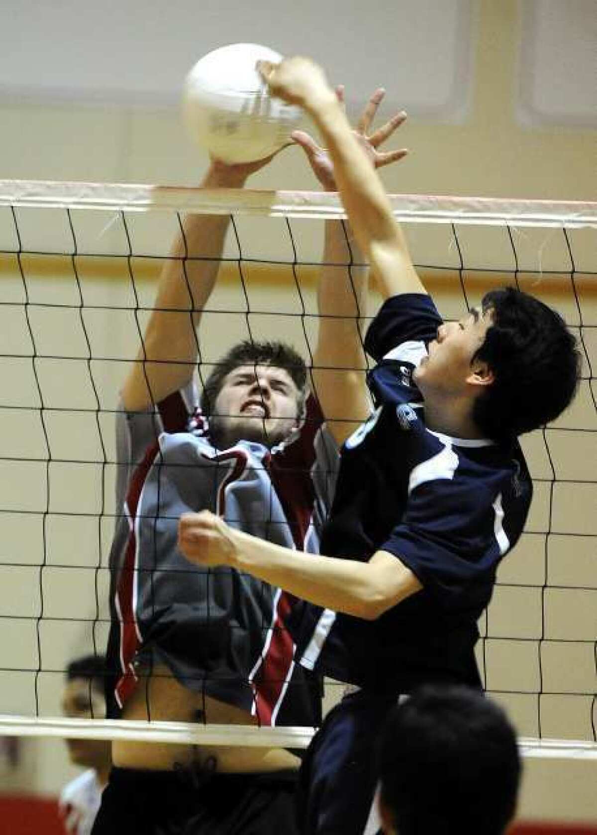 Burroughs' Daniel Marback, left, and Crescenta Valley's Christopher Han each try to tally a point for their teams at the net.