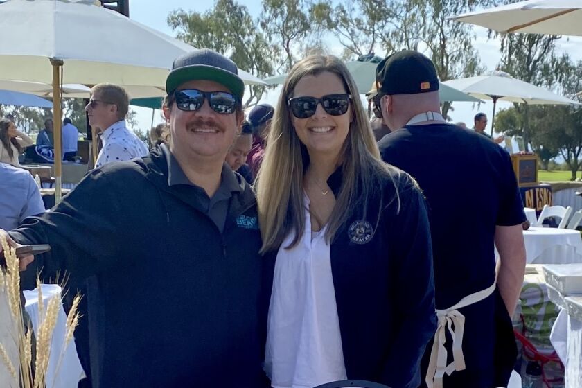 Husband and wife Troy and Haley Smith of Ocean Beach attend an event promoting their business, Belching Beaver Brewery.