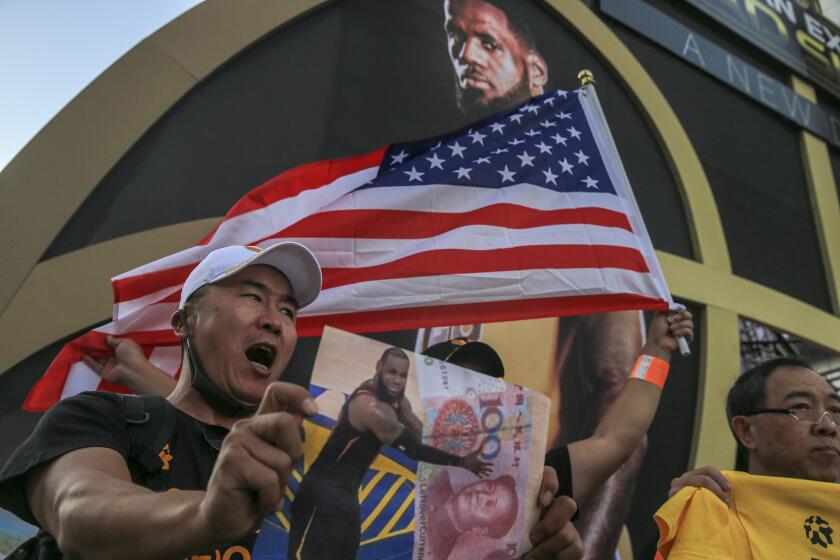 LOS ANGELES, CA, TUESDAY, OCTOBER 22, 2019 - Yang Wang chants “free Hong Kong” at the corner of Figueroa and Chick Hearn Court before the Lakers Clippers game at Staples Center. (Robert Gauthier/Los Angeles Times)