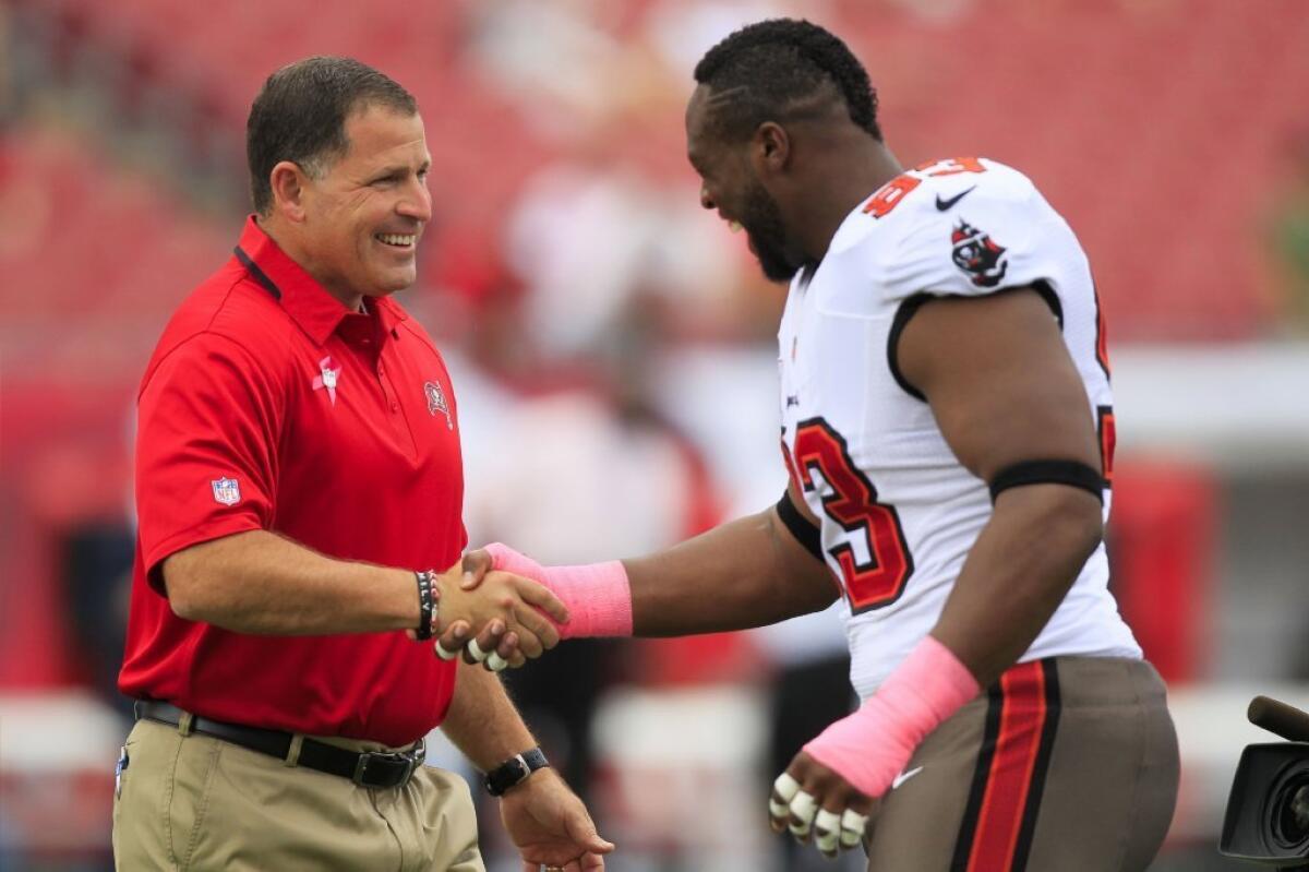 Tampa Bay Buccaneers Coach Greg Schiano shakes hands with Gerald McCoy before the Oct. 13 game against Philadelphia.