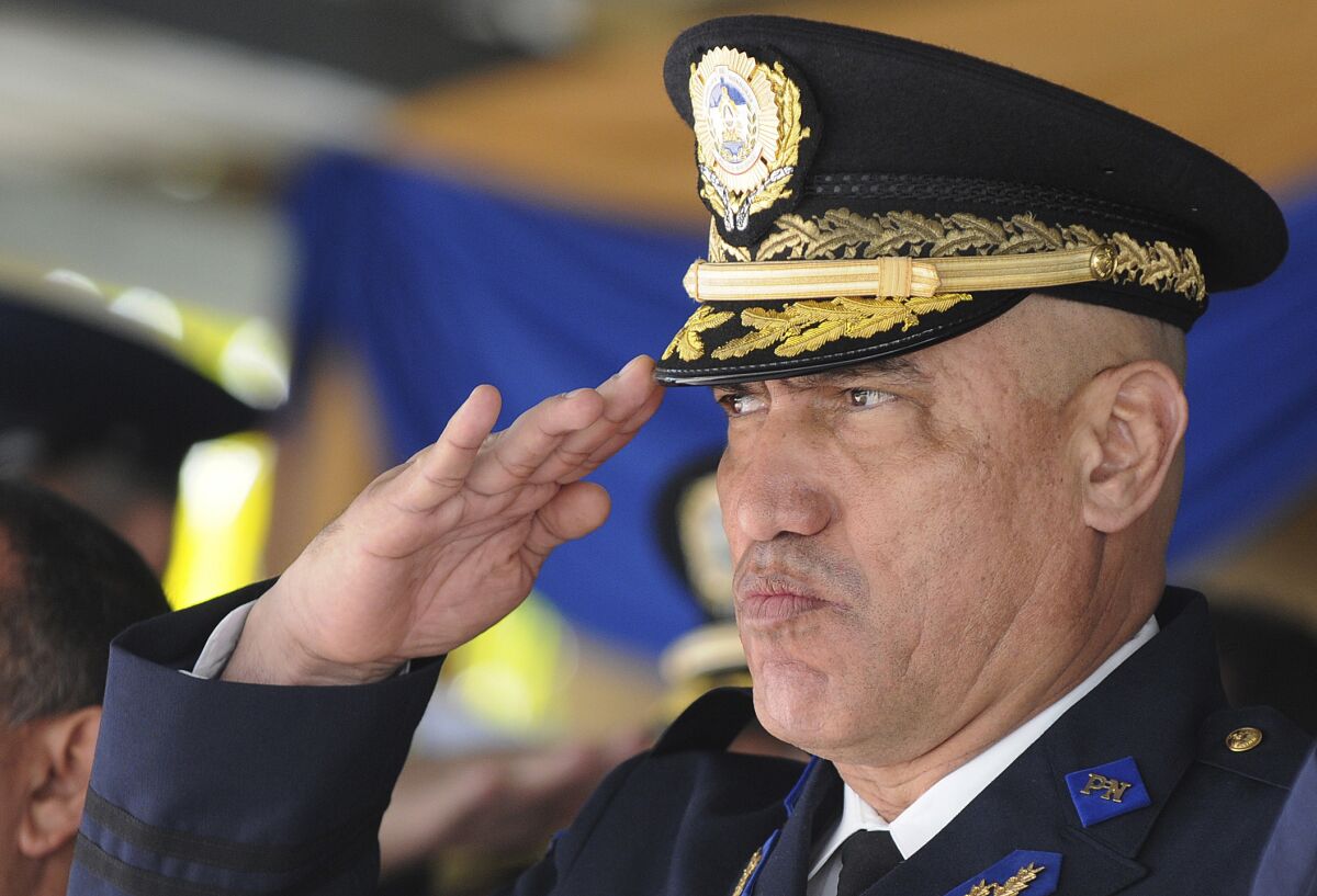 FILE - Honduras Police Chief Gen. Juan Carlos Bonilla Valladares, also known as the Tiger, or "El Tigre," salutes during an event in Tegucigalpa, Honduras, Dec. 21, 2012. The former national police chief of Honduras made an initial appearance in a New York courtroom Wednesday, May 11, 2022, after his extradition to the United States to face criminal drug trafficking charges, a day after the former president of the Central America country, President Juan Orlando Hernández, pleaded not guilty to related criminal charges. (AP Photo/File)