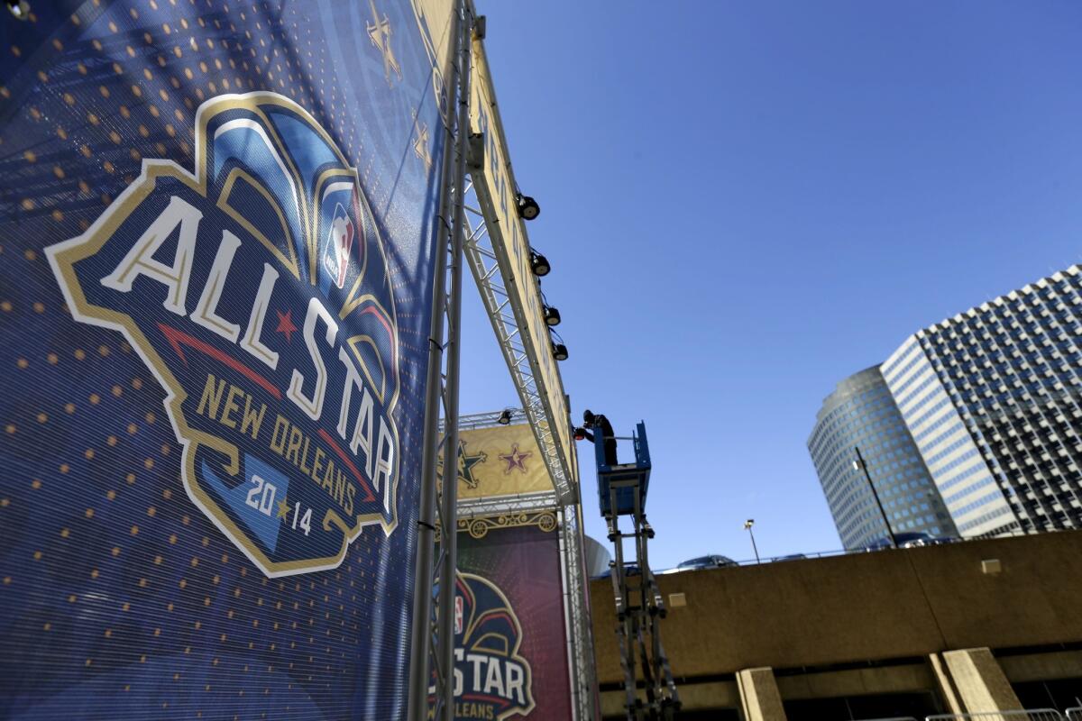 A banner goes up in New Orleans prior to the 2014 NBA All-Star game.