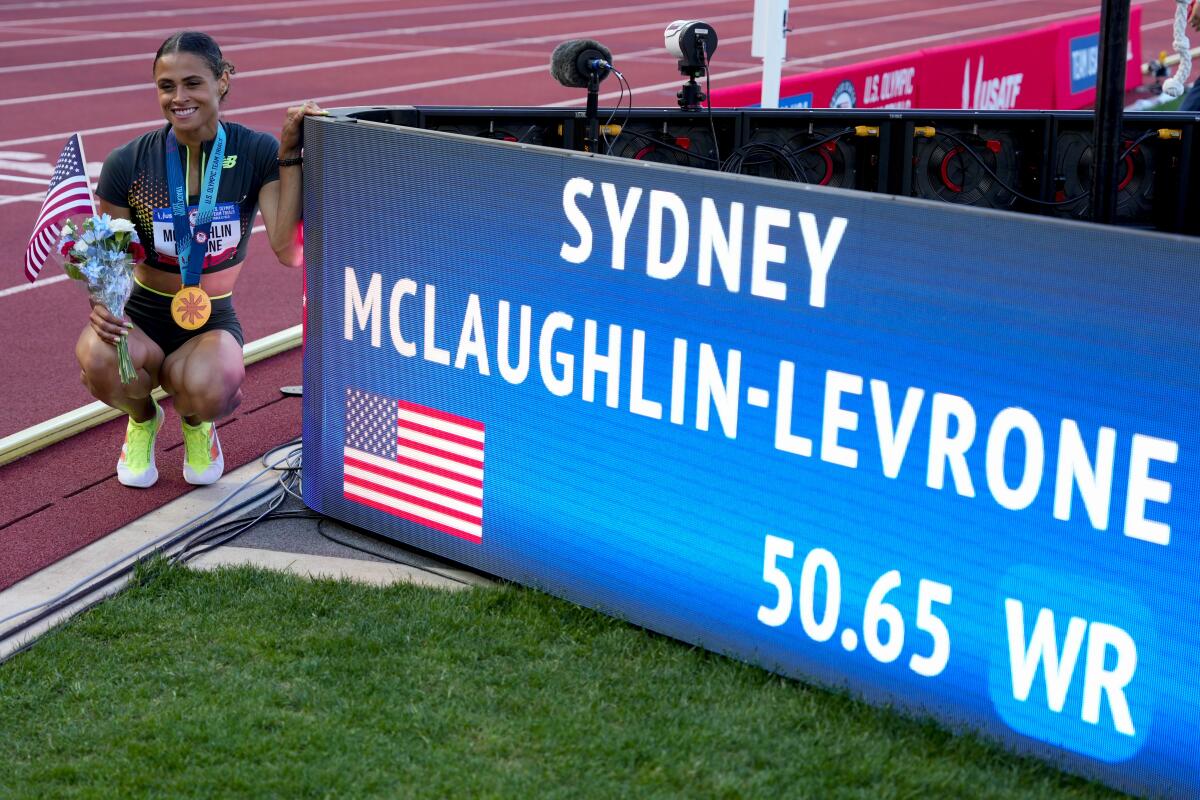 Sydney McLaughlin-Levrone poses for a photo after setting a world record in the women's 400-meter hurdles.