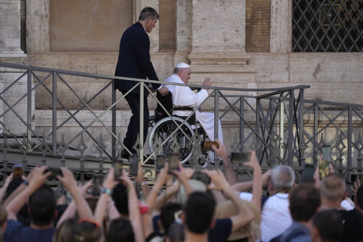 FILE-- Pope Francis greets the faithful as he leaves St. Mary Major Basilica after participating in a rosary prayer for peace, in Rome, Tuesday, May 31, 2022. Pope Francis canceled a planned July trip to Africa on doctors' orders because of ongoing knee problems, the Vatican said Friday, June 10, 2022, raising further questions about the health and mobility problems of the 85-year-old pontiff. (AP Photo/Gregorio Borgia)