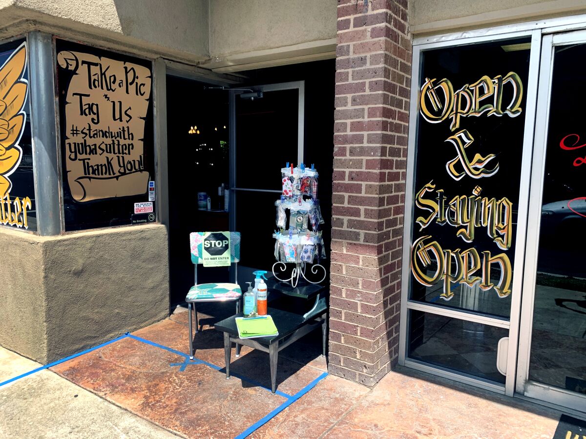 Anyone who enters Rockabetty's Hair Parlor in Yuba City must have their shoes sprayed with disinfectant and their hands sanitized. Clients and stylists sign release forms stating that the parlor is not liable if they contract the coronavirus at the facility or any time after that.