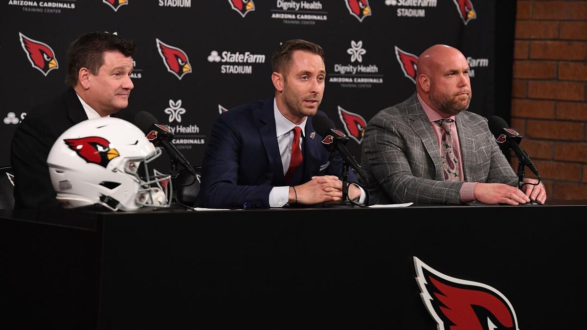 Arizona Cardinals team president Michael Bidwill, left, and general manager Steve Keim, right, introduce the new head coach Kliff Kingsbury to the media at the Arizona Cardinals Training Facility on Wednesday in Tempe, Ariz.