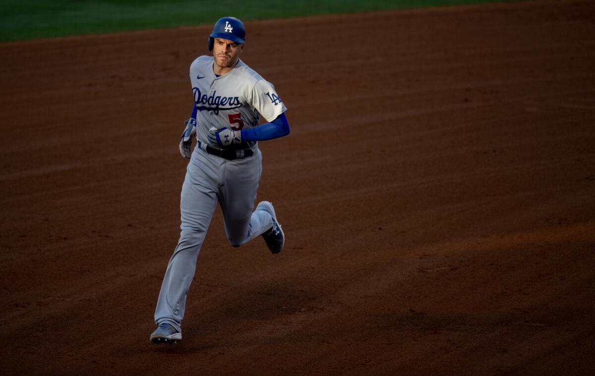 Freddie Freeman rounds the bases after hitting a home run in the fourth inning.