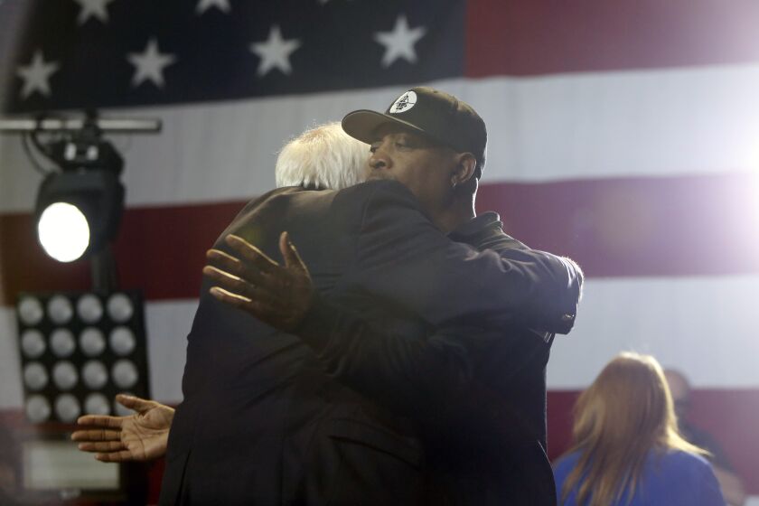 LOS ANGELES, CALIFORNIA-March 1, 2020: Rapper Chuck D gives a hug to Bernie Sanders as he enters the stage to perform during a Bernie Sanders rally at the Los Angeles Convention Center on March 1, 2020, in Los Angeles, California. (Photo By Dania Maxwell / Los Angeles Times)