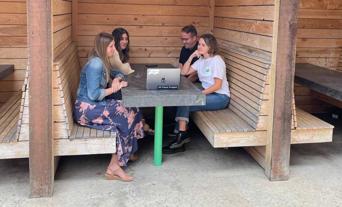 Staff at Flock Freight work outside at the company's office in Encinitas.
