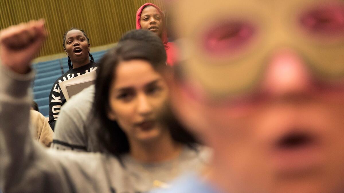 Youth Justice Coalition member Zahria Thomas, left, shouts along with other demonstrators while interrupting the Board of Supervisors meeting in Los Angeles.
