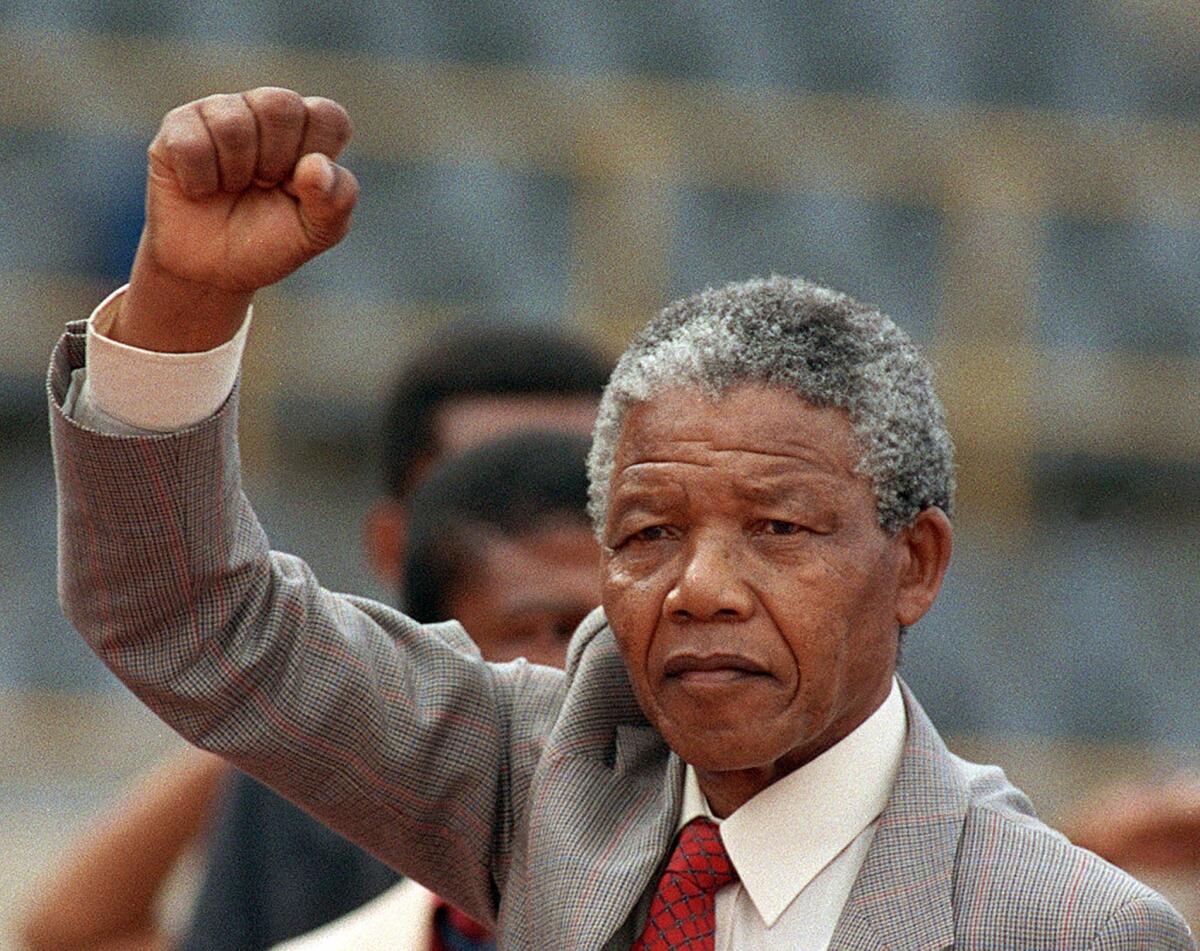 Nelson Mandela is seen arriving to address a mass rally in the conservative Afrikaaner town of Bloemfontein a few days after his release from jail in 1990.
