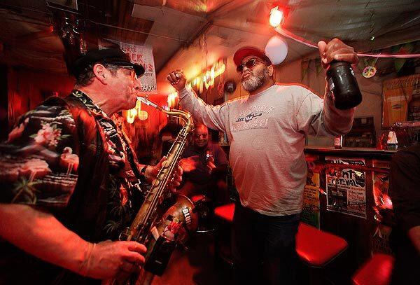 Red Paden, owner of Red's Blues Club in Clarksdale, Miss., grooves with saxophone player Dick Lourie at a tribute to Delta bluesman Big Jack Johnson, who died March 14, 2011.