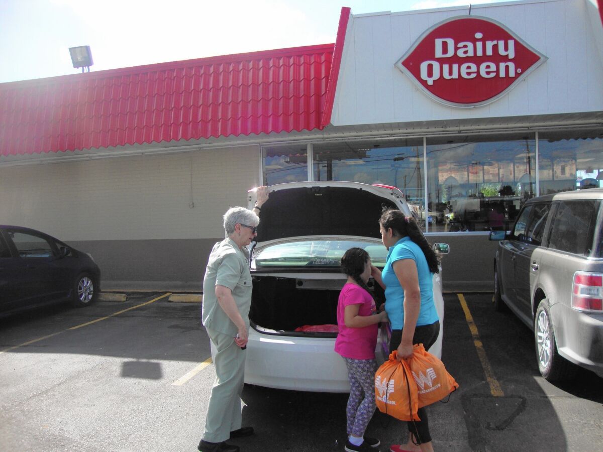 Sister Sharon Altendorf, left, stops for sundaes with Karen and daughter Joanna, newly released from an immigrant family detention center in Karnes City, Texas.