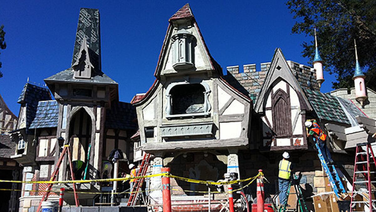 Construction crews work on the exterior of the Fantasy Faire princess meet-and-greet area at Disneyland.