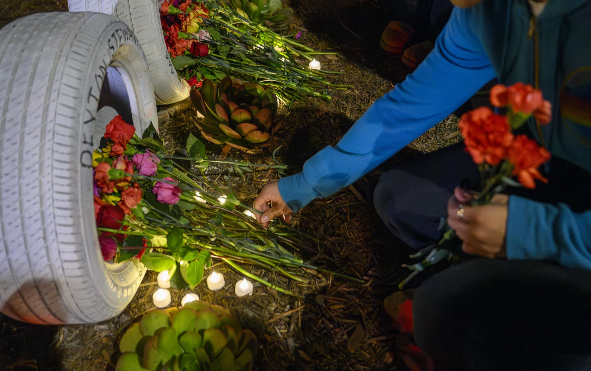 Flowers in front of the "Ghost Tire" memorial for Peyton Stewart, one of the four Pepperdine students killed one year ago