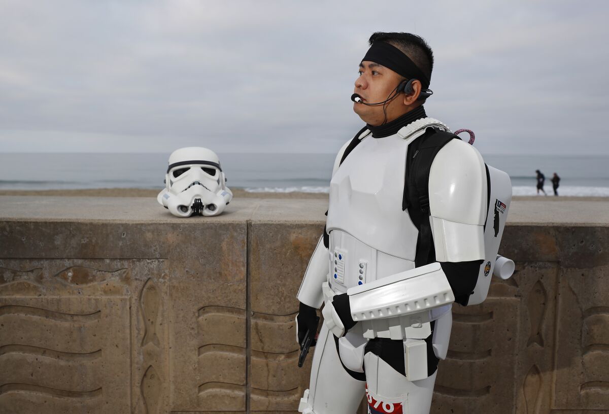 Jeffry Priela, 38, of Carlsbad, gets ready to walk down Highway 101 in his Star Wars stormtrooper armor.