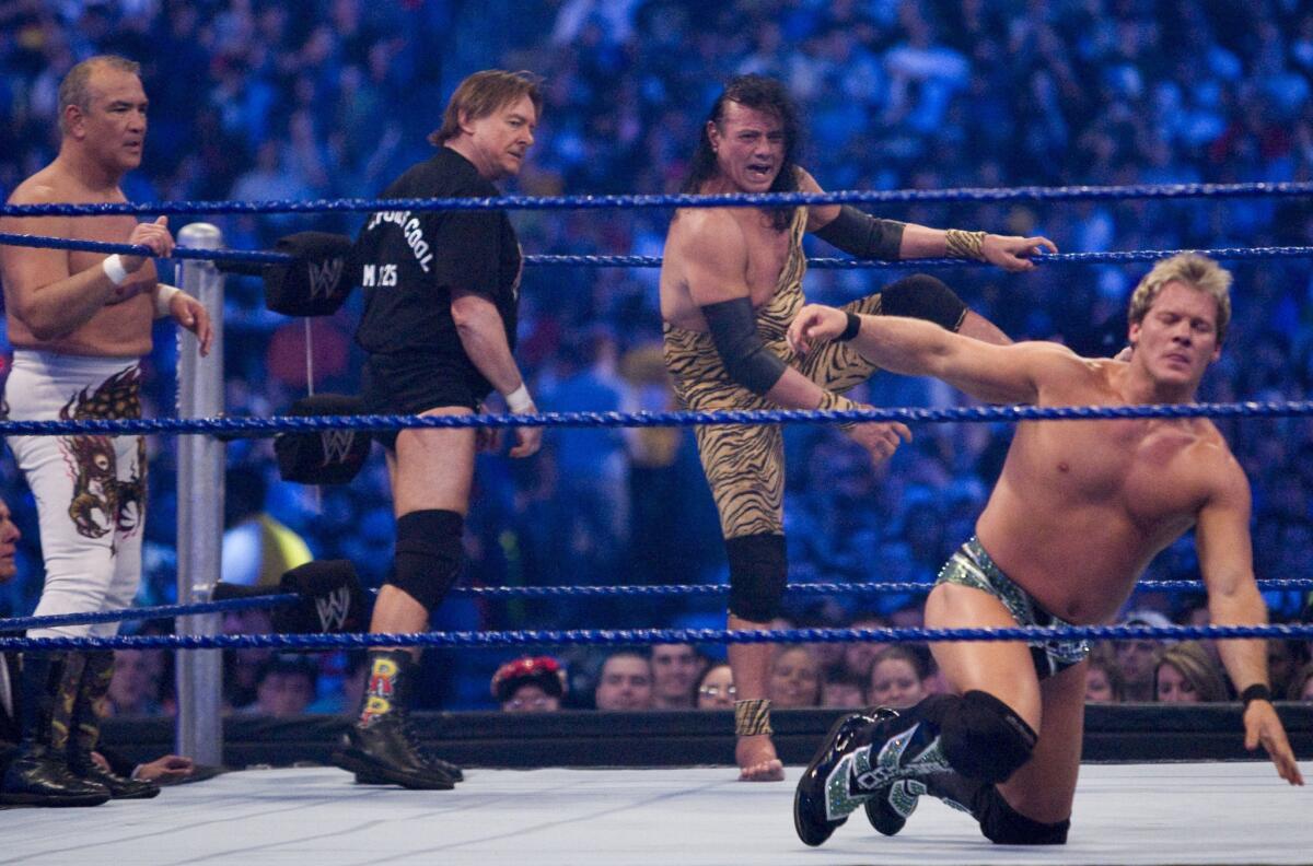 Jimmy "Superfly" Snuka steps into the ring to battle WWE Superstar Chris Jericho, right, as Ricky "The Dragon" Steamboat and Rowdy Roddy Piper look on during WrestleMania 25 in Houston on April 5, 2009.