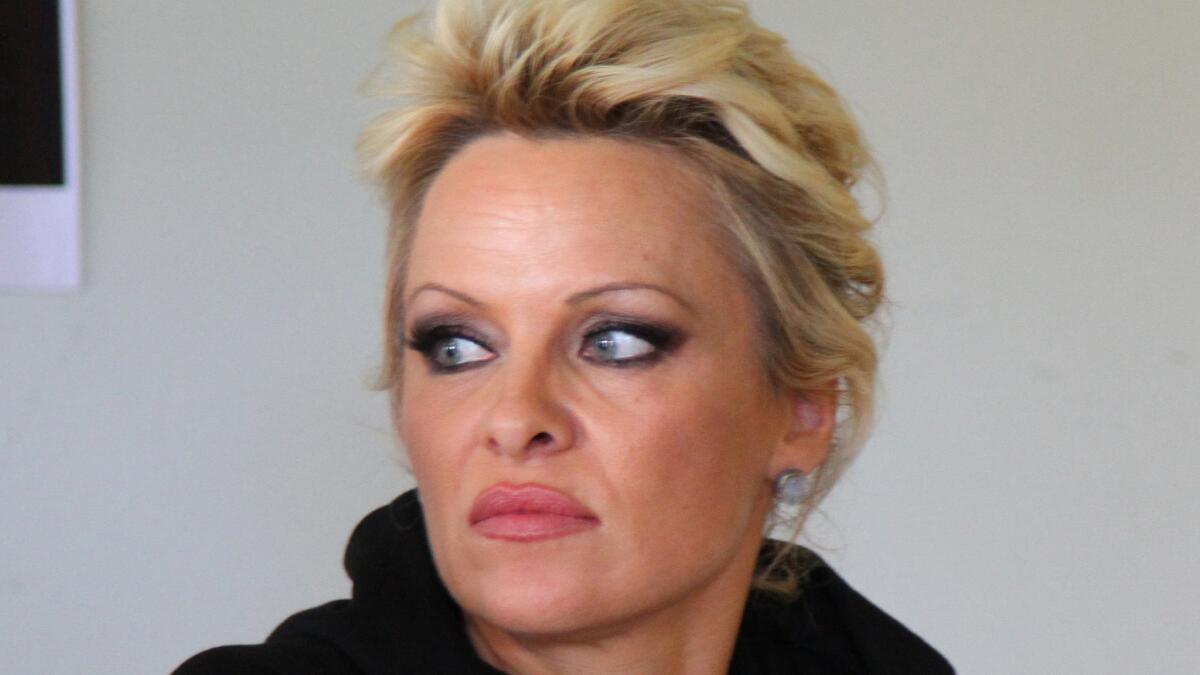 Pamela Anderson, shown at a news conference in the Faeroe Islands in early August, has asked the court to toss her July petition for divorce from Rick Salomon.