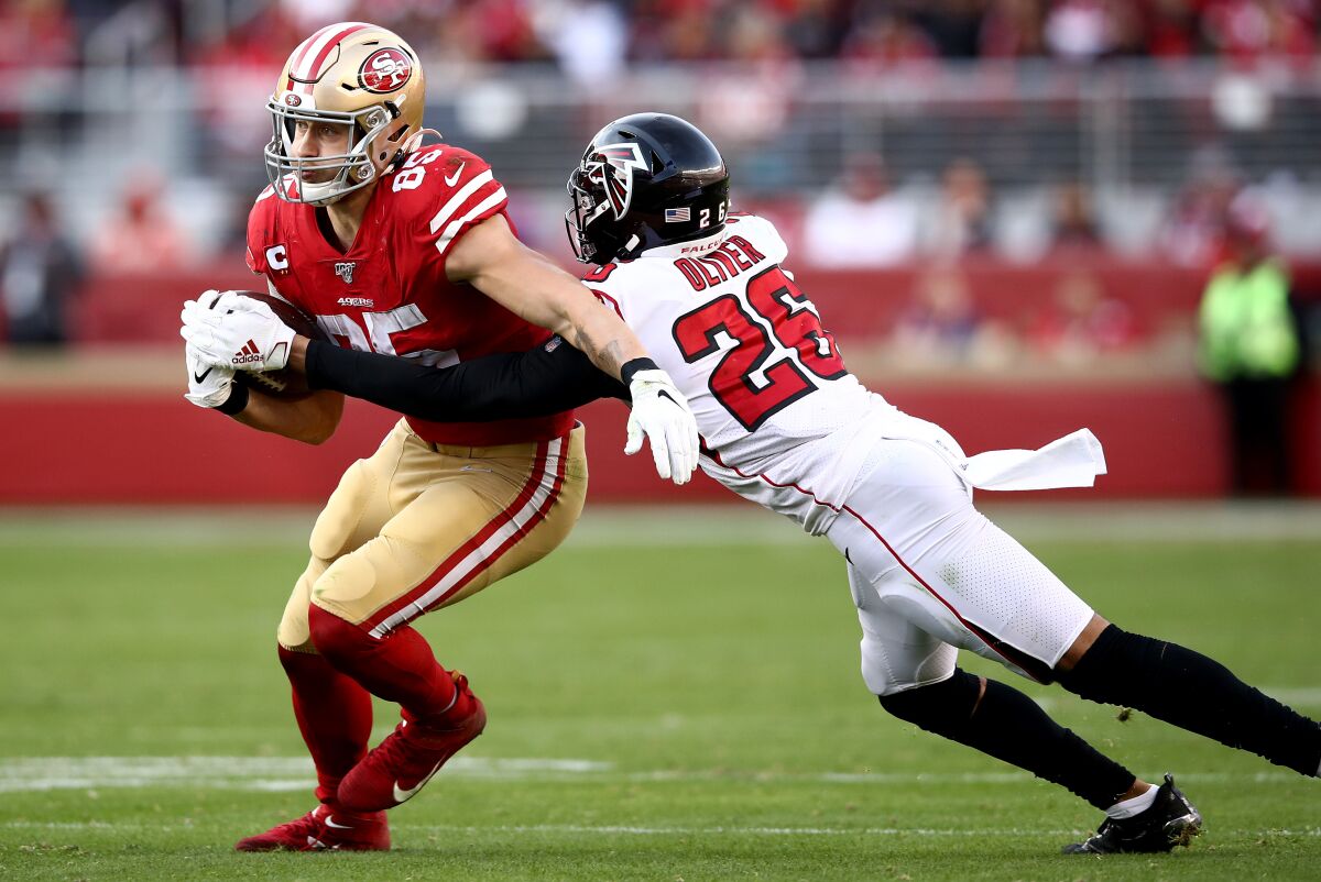 Falcons cornerback Isaiah Oliver tries to tackle 49ers tight end George Kittle on Dec. 15, 2019.