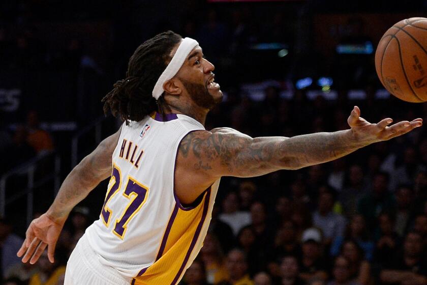 Lakers forward Jordan Hill reaches for a rebound during a win over the Boston Celtics on Feb. 22, 2015.