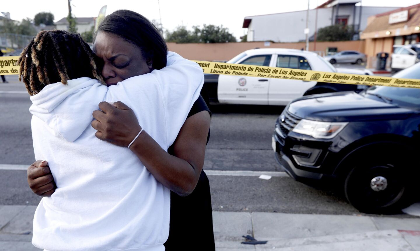 Marquesa Lawson, 34, right, mourns the shooting death of rapper Nipsey Hussle in the Hyde Park neighborhood of Los Angeles.