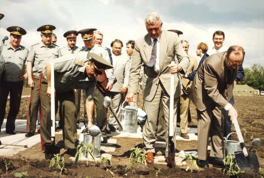 This June 4, 1996, photo provided by William Perry, shows, from left, Russian defense minister Pavel Grachev, Ukrainian Defense Minister Valery Schmarov, and U.S. Defense Secretary William Perry planting sunflowers at the site which formerly housed a missile silo at a military base near Pervomaysk, some 155 miles south of Kyiv, Ukraine. (Department of Defense via AP)