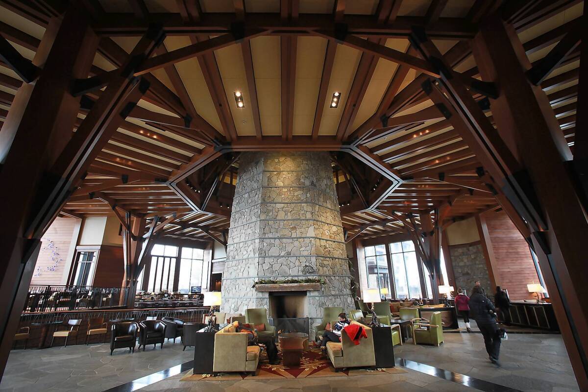 Cozy seating areas surround the stone fireplace column at the Ritz-Carlton hotel at the Northstar resort near Lake Tahoe. Ritz-Carlton invested $300 million to open the six-story, 170 guest room luxury hotel in 2009; it is the only five-diamond, AAA-rated hotel around the lake.