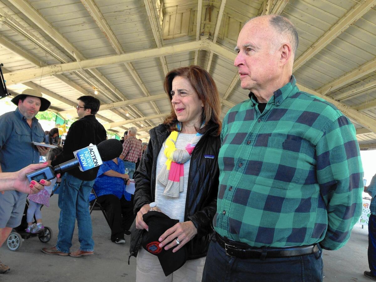 Gov. Jerry Brown and his wife, Anne Gust, make the rounds at the western festival in Colusa, where they helped judge a cooking contest.