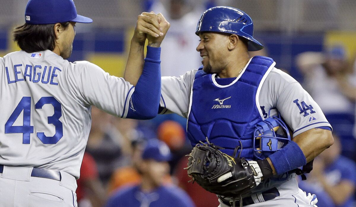 Dodgers reliever Brandon League is congratulated by catcher Miguel Olivo in happier times, after a 9-7 victory over the Miami Marlins on May 3.
