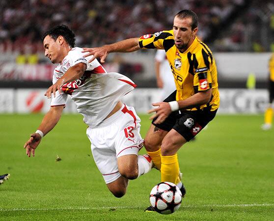 VfB Stuttgart defender Ricardo Osorio, left, vies for the ball with FC Timisora's Iasmin Latovlevici in a UEFA Champions League match in Stuttgart, Germany.