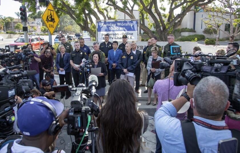 Officials hold a news conference in front of Geneva Presbyterian Church in Laguna Woods