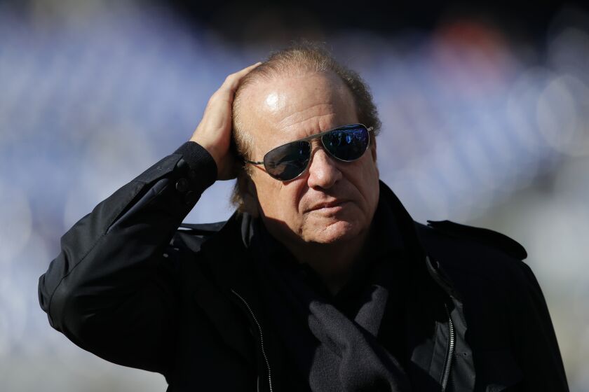 Los Angeles Chargers owner Dean Spanos walks on the field before an NFL wild card playoff football game against the Baltimore Ravens, Sunday, Jan. 6, 2019, in Baltimore. (AP Photo/Carolyn Kaster)