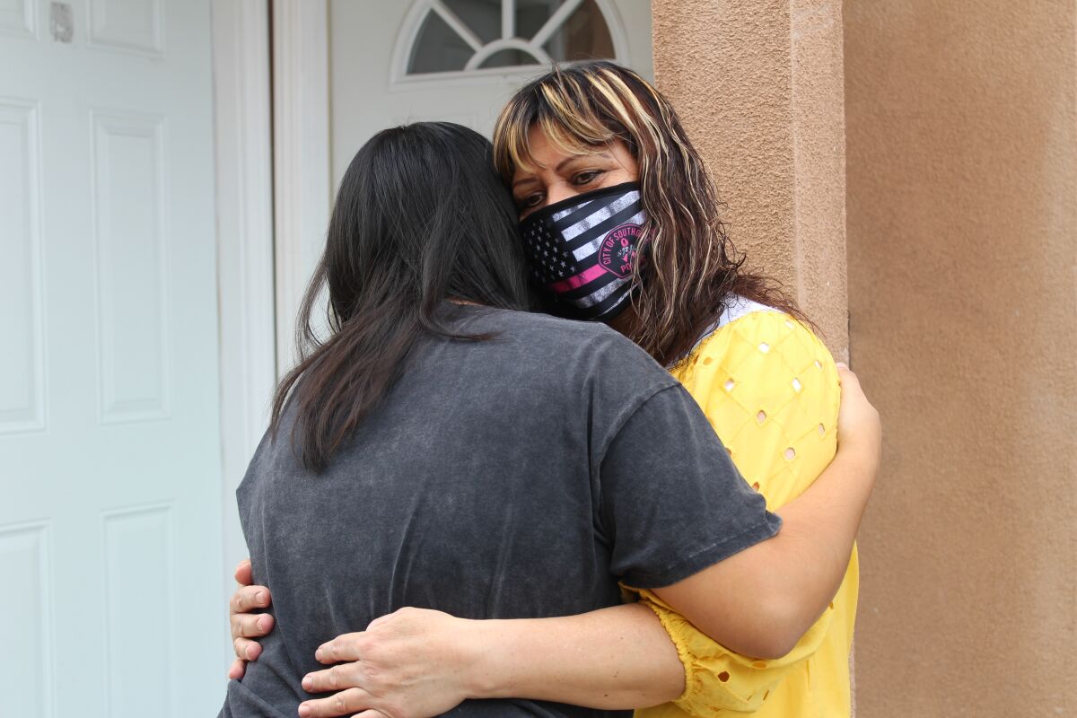 Rosa Amarillas, a breast cancer survivor from Los Angeles, hugs her 14 year daughter Ashley