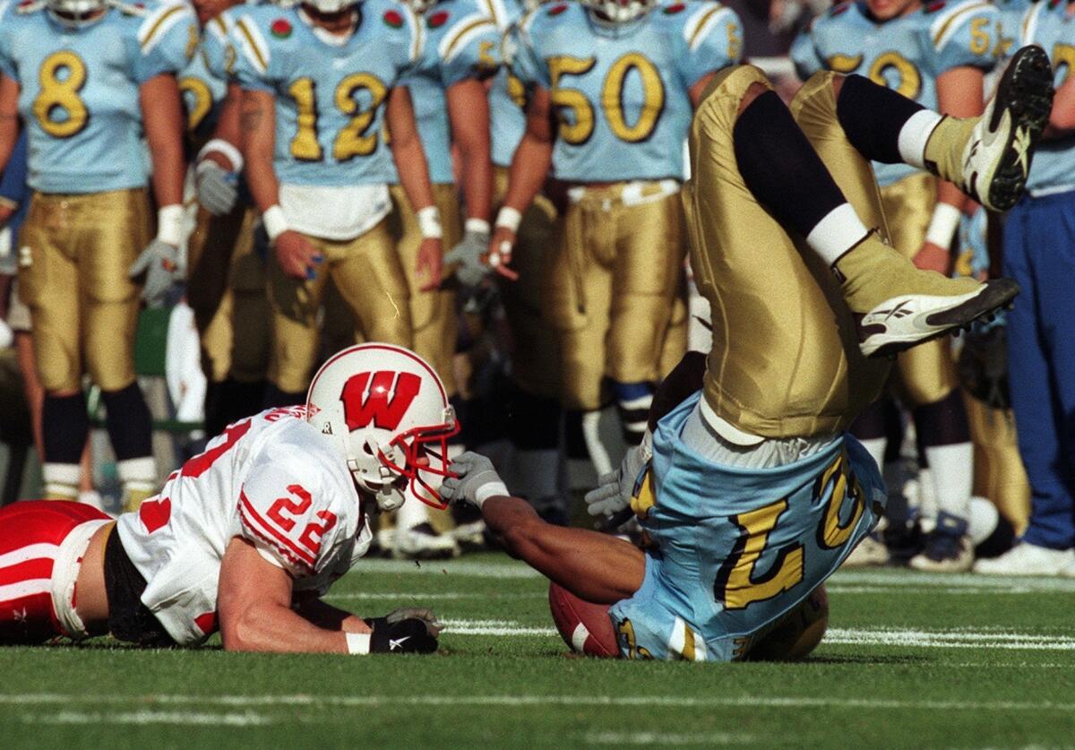 UCLA's Tod McBride goes down after Wisconsin's Nick Davis is hit while trying to receive a punt in the first quarter of the 1999 Rose Bowl game.