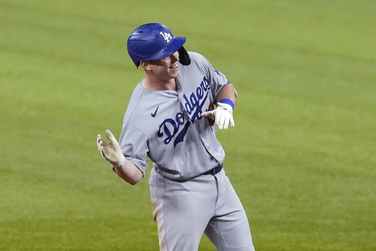 Dodgers catcher Will Smith gestures as he celebrates after hitting a two-run double in the ninth inning.
