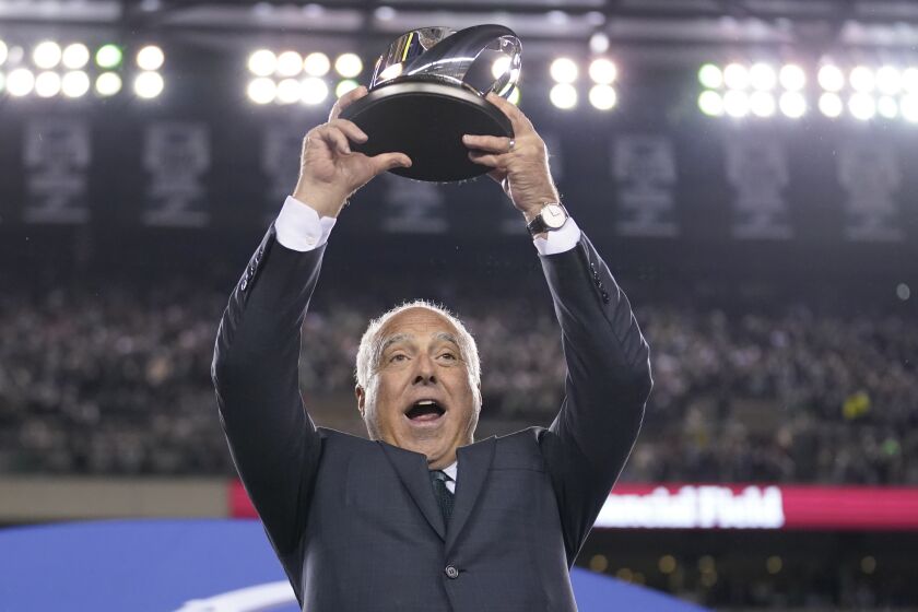 Philadelphia Eagles owner Jeffrey Lurie hoists the George Halas Trophy after the NFC Championship NFL football game between the Philadelphia Eagles and the San Francisco 49ers on Sunday, Jan. 29, 2023, in Philadelphia. The Eagles won 31-7. (AP Photo/Matt Slocum)
