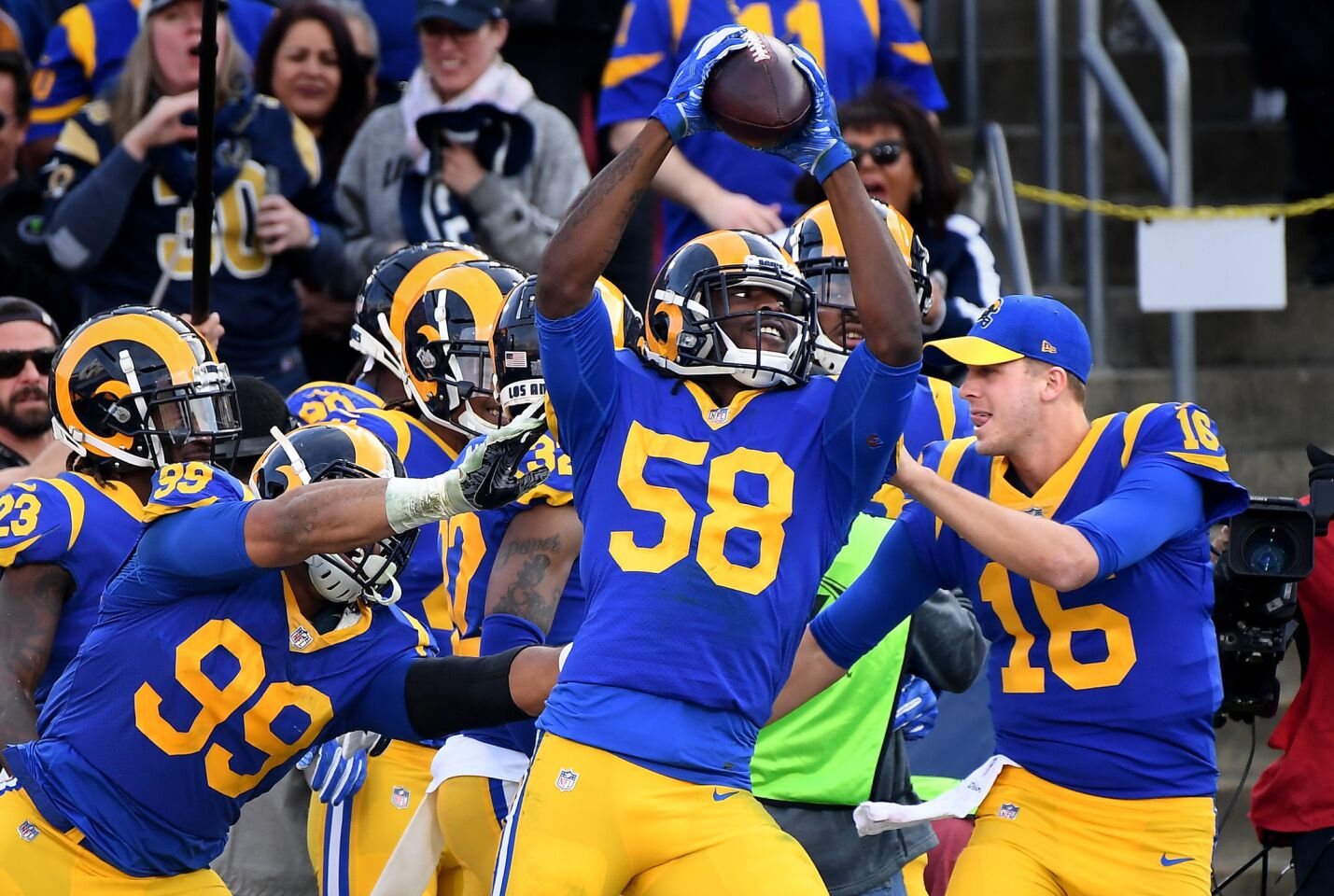 Rams linebacker Cory Littleton celebrates a touchdown with teamates after intercepting a pass against the 49ers.